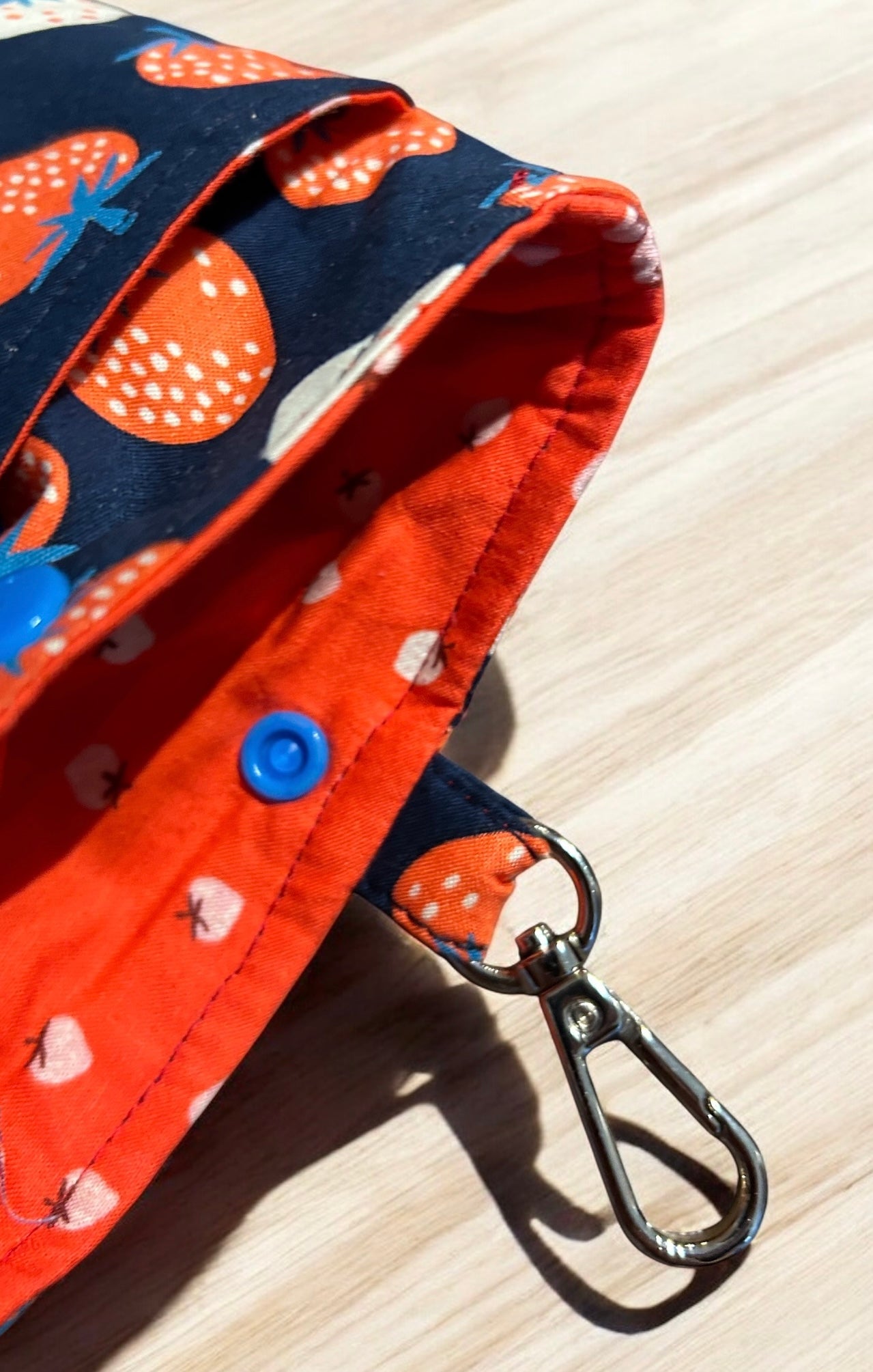 Fabric with orange and blue pattern on a wooden surface