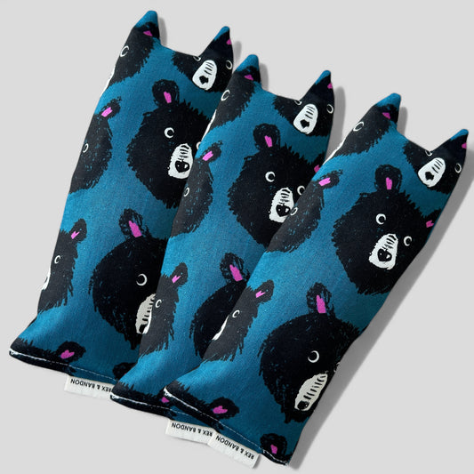 Three blue socks with black bear designs on a light gray background