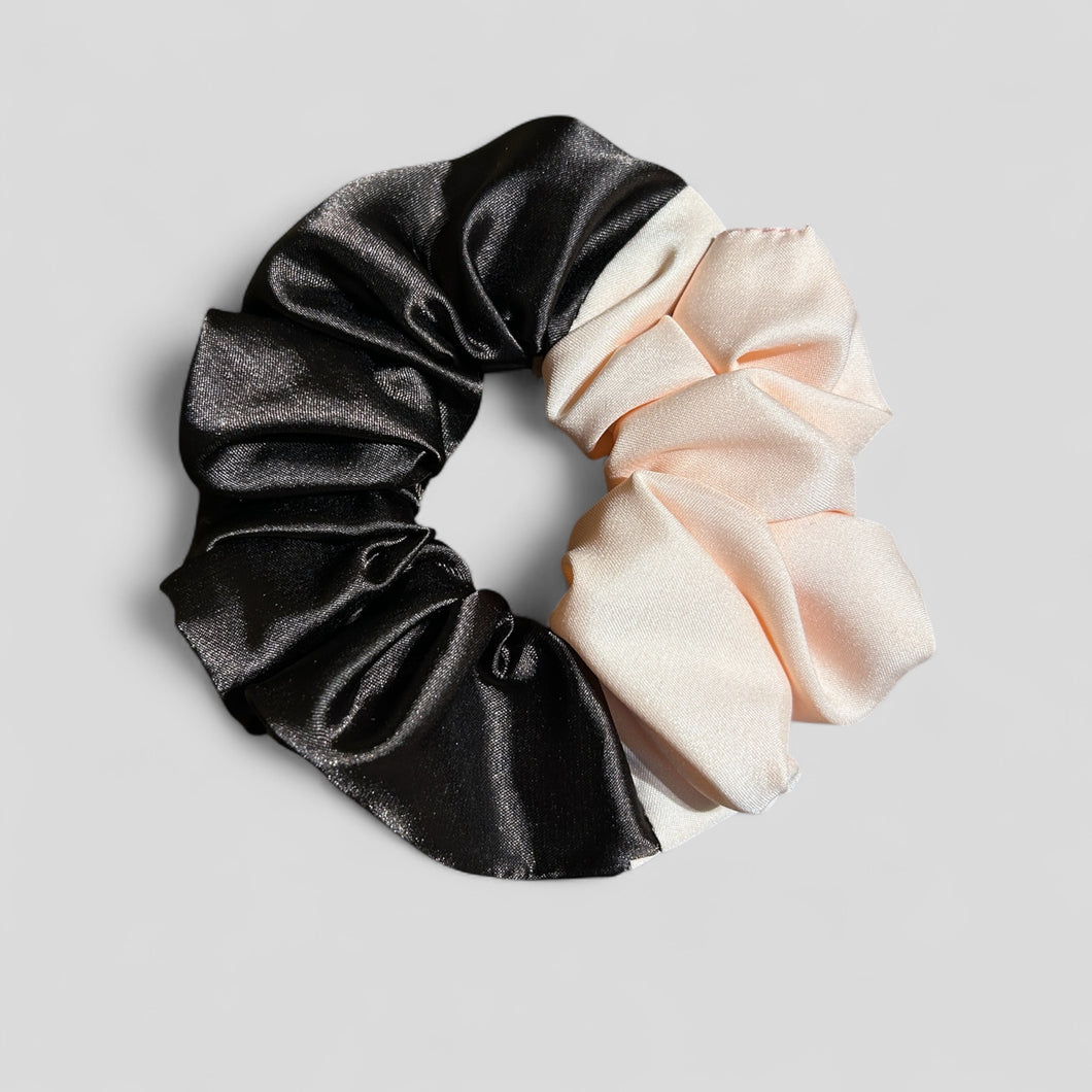 Black and beige scrunchies on a light gray background