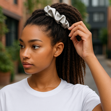 Load image into Gallery viewer, Woman adjusting a scrunchie in her hair outdoors
