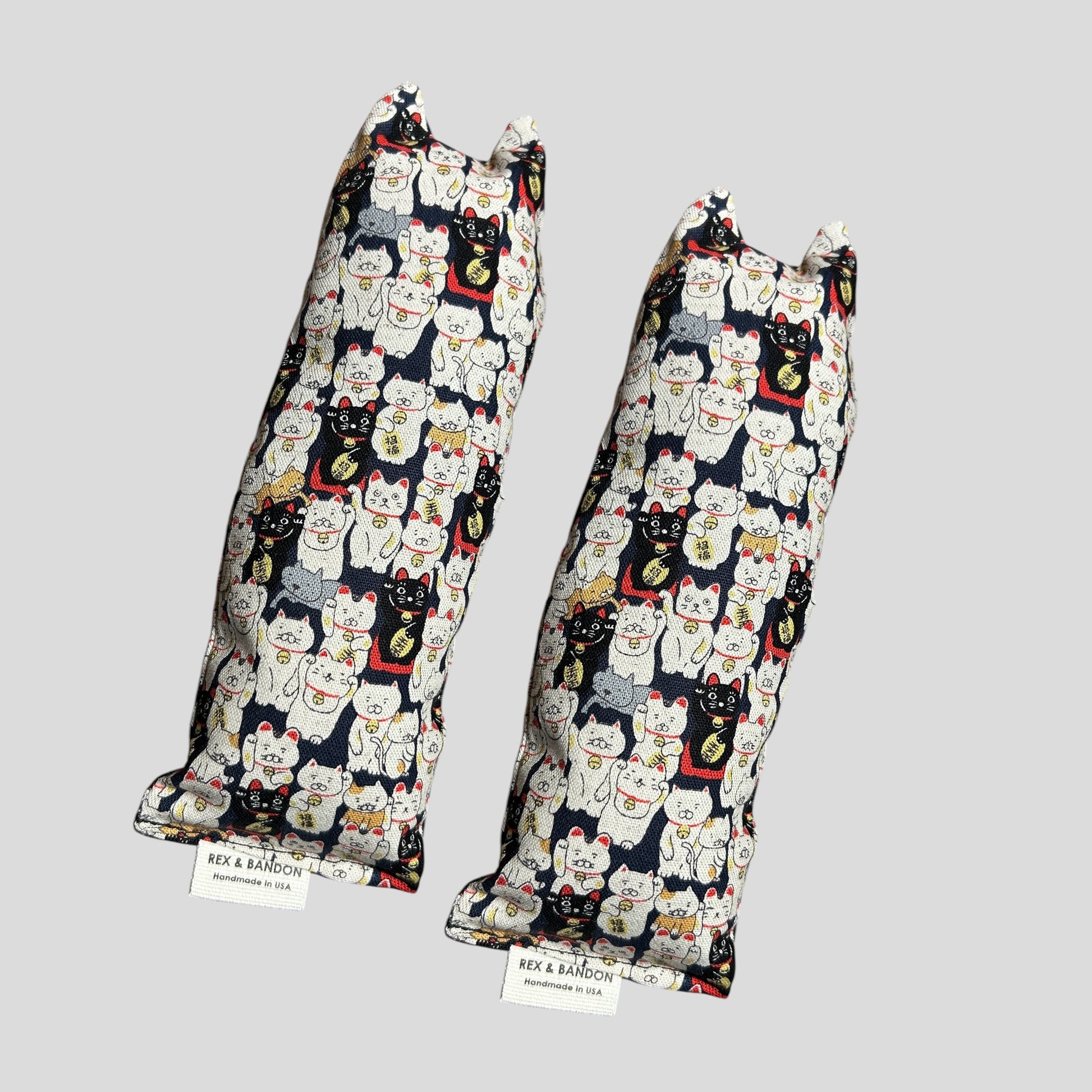 Two pairs of leggings with cat pattern on a gray background