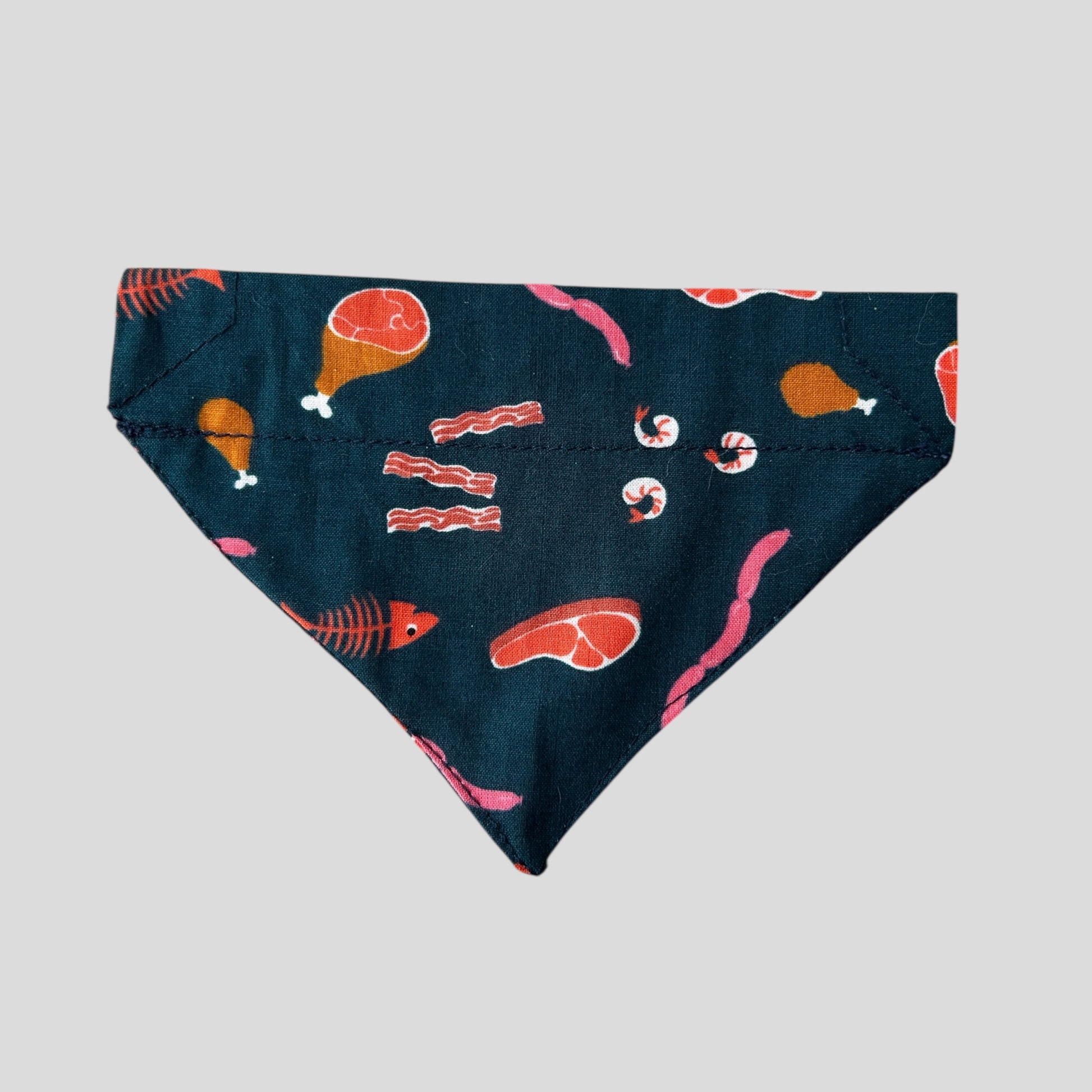 Navy blue bandana with food-themed pattern on a light gray background