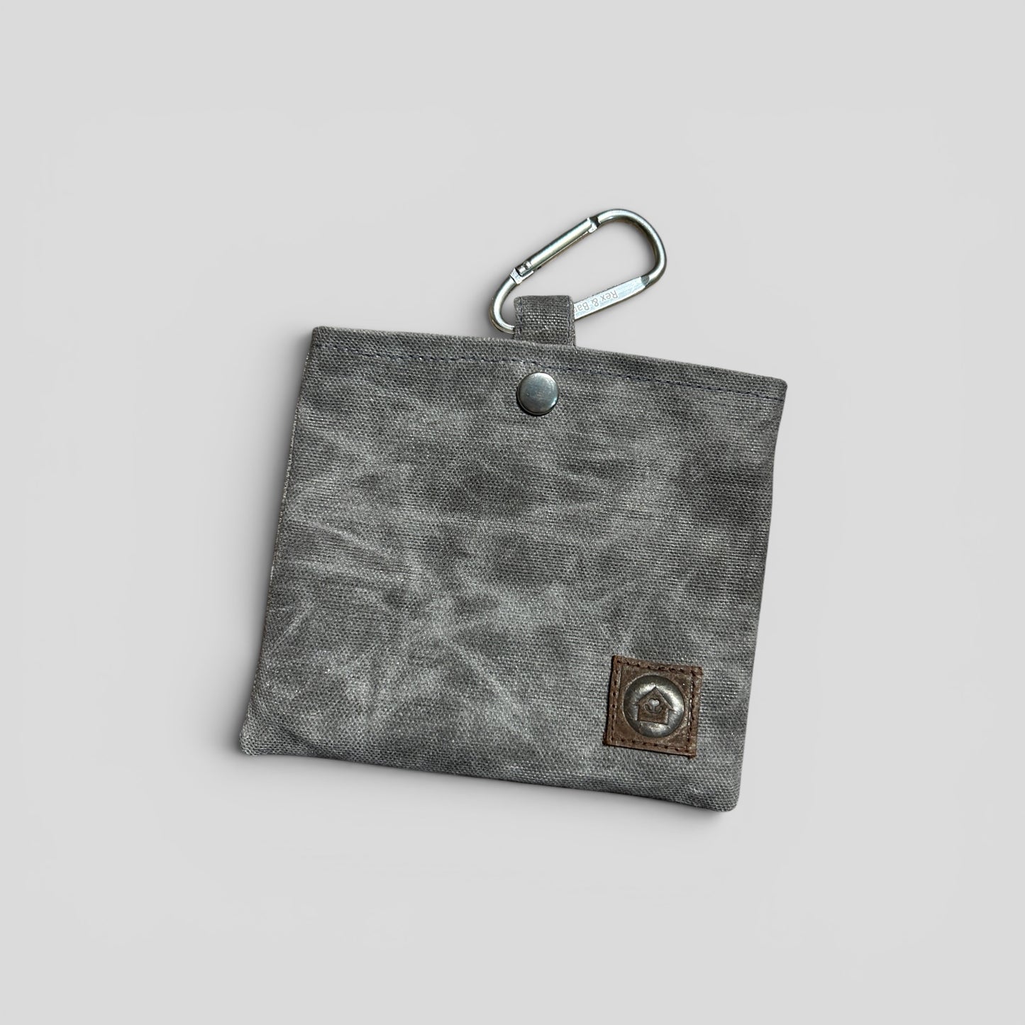 Gray fabric key pouch with carabiner on a light gray background