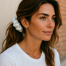 Load image into Gallery viewer, Woman with a white scrunchie in her hair against a neutral background