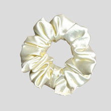 Load image into Gallery viewer, Cream-colored satin scrunchie on a light gray background