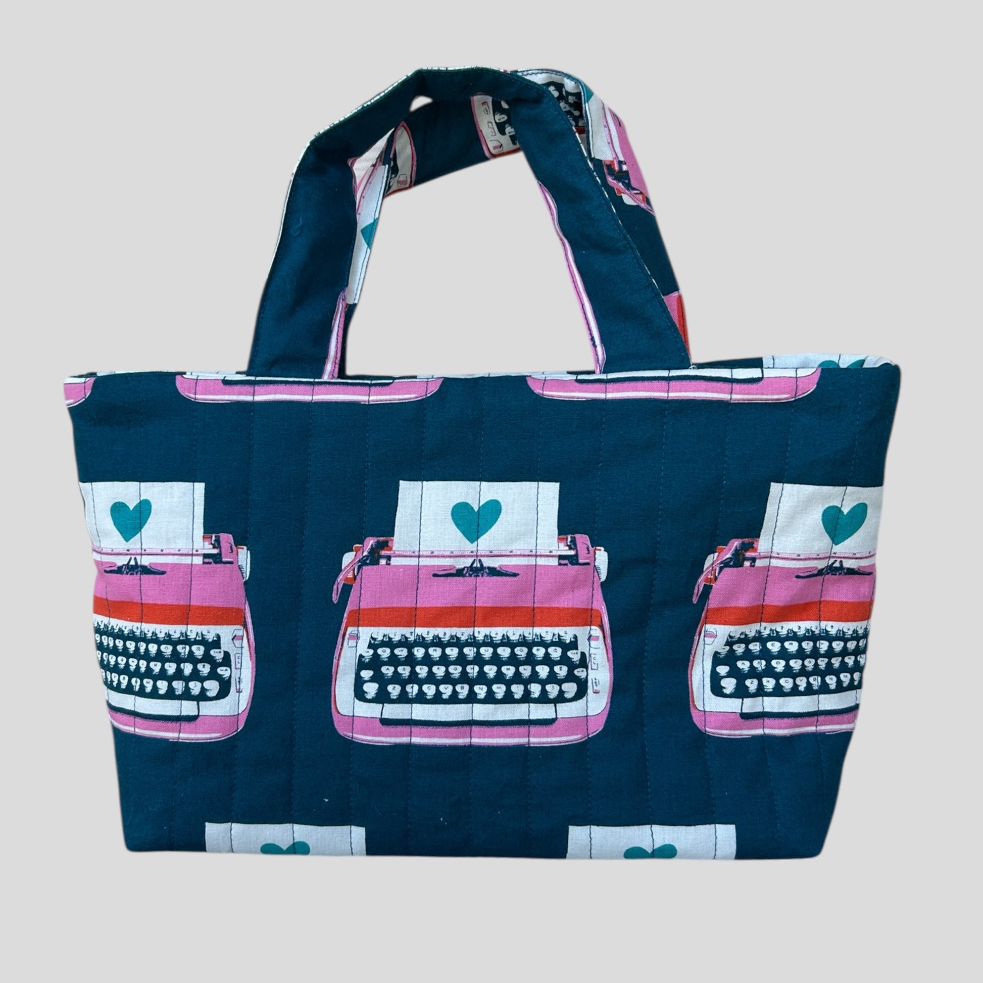 Tote bag with typewriter design on a plain background