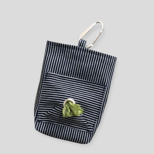 A striped cotton dog walker pouch with a front pocket and a carabiner clip, against a white background.